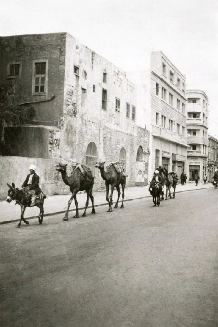 A caravan on Derech HaAtsma'ut, passing the Ottoman stone that still stands at the corner.