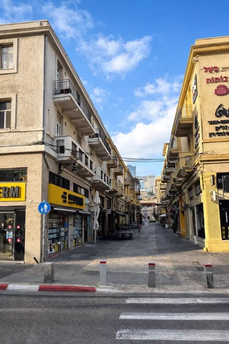The same street this morning — shutters up, the quarter waking slowly.
